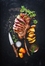Grilled Meat, Sliced ​​tomahawk Beef Steak With Spices, French Fries And Vegetables