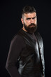 © be free - Man confident and brutal style black background. Barbershop concept. Grow mustache. Fashion model. Strict mature face. Facial hair. Male face. Handsome face. Man with beard in black leather clothes