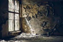 Ruined Walls Of An Abandoned Building Under The Sunlight Coming From The Broken Window