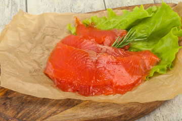 Sliced salmon fillet served rosemary