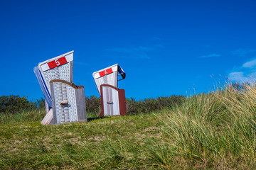 Two beach chairs on the dike