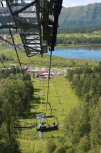 Cable car with open seating areas. Russia, Altai, Lake Manzherok. The highest cableway in Russia. Beautiful views and tourism, entertainment advertisements and cable cars, climbing the mountain.