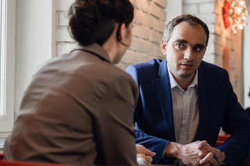 Business woman and business man having a meeting in a cafe