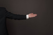 © Galina_lya - hand of a man wearing formal suit with palm up side view over dark background