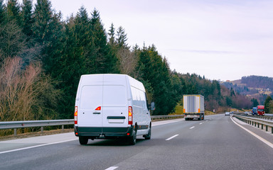 Canvas Print - White Minivans on road van transport logistics reflex