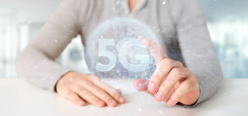 Poster - Businessman holding a 5G connection with data surrounding - 3d rendering