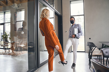 Wall Mural - Man with a laptop meeting his female coworker