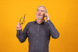 © carballo - adult or senior man with mobile phone isolated on color background