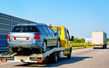 Canvas Print - Tow truck transporter carrying car on Road in Slovenia reflex