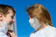 © Ivan Zelenin - Children in a city park in a medical mask. Walking on the street during the quarantine period of the coronavirus pandemic in the world. Precautions and teaching children