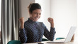 © fizkes - Happy indian woman office worker feeling excitement raising fists celebrates career ladder promotion or reward, businesswoman sitting at desk receive online news, great results successful work concept