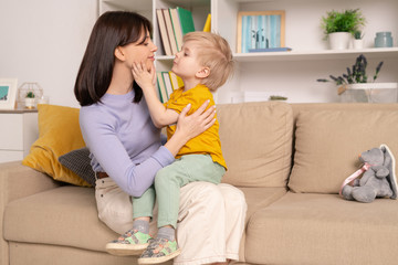 Poster - Happy young affectionate mother and her little son expressing love to each other