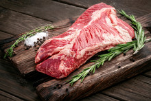 Raw Hanging Tender Or Onglet Steak Of Beef On Wooden Board With Rosemary And Thyme On Wooden Background