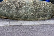The Elaborately Decorated Kerb Stone 1 At The Entrance To Newgrange Passage Tomb In The Boyne Valley Ireland.  The Carved Triple Spiral Is The Most Recognisable Symbol Of Megalithic Art In Ireland.