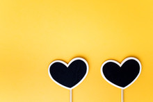 Two Black Heart Sticker On Yellow Background. Love, Relationship Concept