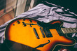 Semihollow sunburnt guitar body on a blue sheet bed