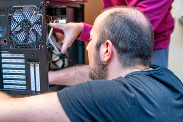 Two technicians assembling a PC