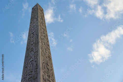 Fotomural The Luxor Obelisk or Egyptian obelisk on the Place de la Concorde against a blue sky in Paris, France