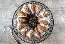 Decorative Gingerbread Bundt Cake With Sugar Glaze Drizzled On Sides Flat Lay