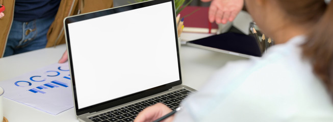 Wall Mural - close up view of businesswoman working on blank screen laptop in meeting room