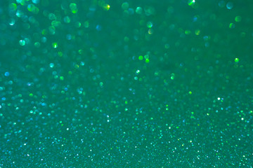 Bubbly sea green glitter texture background with defocused bokeh