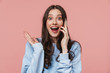 © Drobot Dean - Image of delighted woman expressing surprise and talking on cellphone