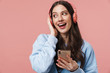 © Drobot Dean - Image of delighted woman laughing while using headphones and cellphone