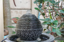 Close Up Rock Feng Shui Ball Fountain In Home Garden
