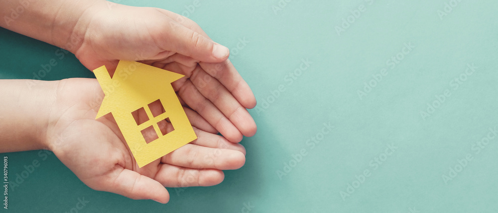 hands holding paper house, family home, homeless housing and home protecting insurance concept, international day of families, foster home care, homeschooling, social distancing - obrazy, fototapety, plakaty 