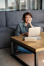 Image Of Nice Young Cheerful Woman Using Laptop And Smiling