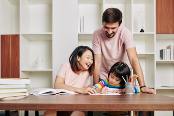 Wall Mural - Parents spending time with daughter and teaching her drawing during quarantine period