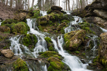  City Cesis, Latvia. Old waterfall with green moss and dolomite rocks.