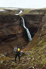 Wall Mural - Traveler by a waterfall