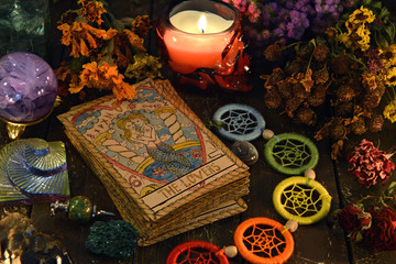 Wall Mural - Tarot cards with chakra decorations, herbs and burning candle.