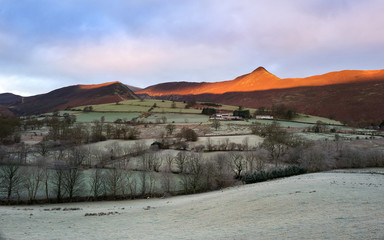 Sticker - A frost covered valley of Newlands with a winters sunrise catching the mountain top of Causey Pike, Derwent Fells in the Lake District.