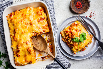 Wall Mural - Classic meat lasagna with cheese on light gray background, top view. Italian food concept.