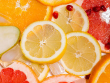 Texture Of Fruit Slices Such As Lemon And Orange Pomegranate And Grapefruit With Ice. Summer Concept
