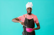 © Carlos David - Portrait of a smiling young male chef cooking with whisker and bowl, against blue studio background