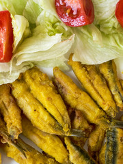 Wall Mural - Anchovies battered with flour and fried with lettuce and tomato