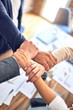 © Krakenimages.com - Group of business workers standing with hands together doing symbol at the office