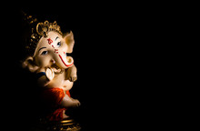 Low Light Photography Of Beautiful Ganesha Statue On Black Background. Worship Concept