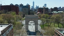 Sunny Day Flying Towards And Tilting Down On Washington Square Arch In NYC