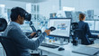 © Gorodenkoff - Modern Industrial Factory: Mechanical Engineer Wearing Virtual Reality Headset, Holding Controllers, Uses VR technology for Industrial Design, Development and Prototyping in CAD Software on Computer.