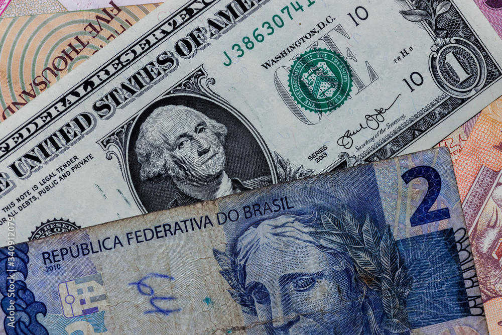 One US Dollar with Different Brazilian Real Banknotes Stock Photo