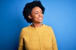 © Krakenimages.com - Young beautiful African American afro woman with curly hair wearing yellow casual sweater looking away to side with smile on face, natural expression. Laughing confident.