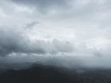 High Angle View Of Mountains Against Cloudy Sky On Foggy Day