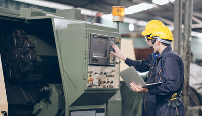 Two technician Mechanic checking on Machine in factory