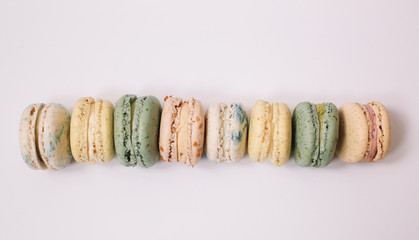 Wall Mural - Homemade 8 colorful macarons on the white background 