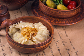 Poster - Russian Vareniky  - dumplings, pickles. Vareniky filled with potato and mushrooms, served with fried onion. Homemade. Background - cyrillic text (russian poem by  A. Pushkin)