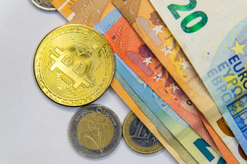 Wall Mural - Golden Bitcoins close-up on euro currency background. High resolution photo